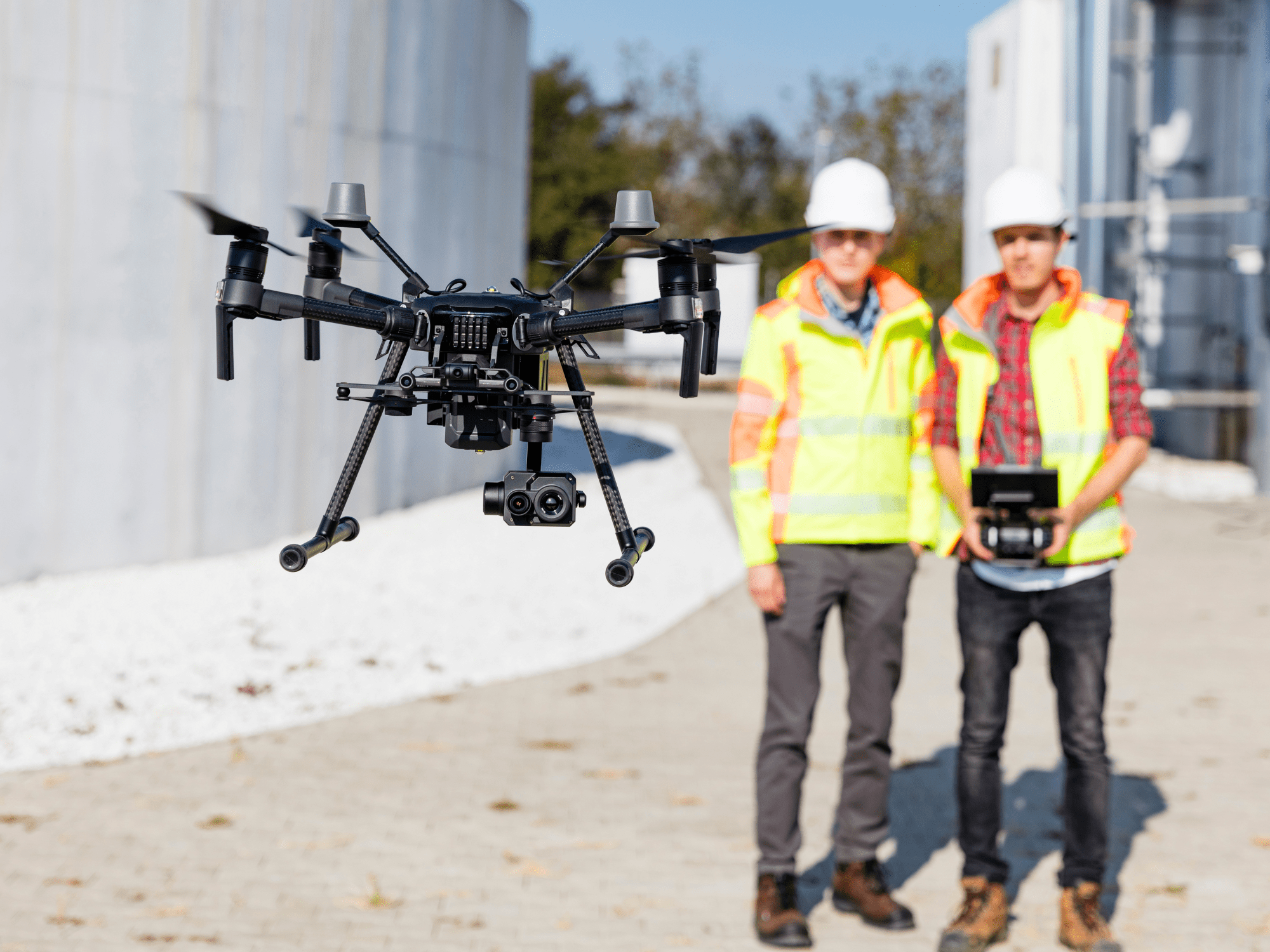 Industrial Drone  Two People Flying A Drone Around An Industrial Site
