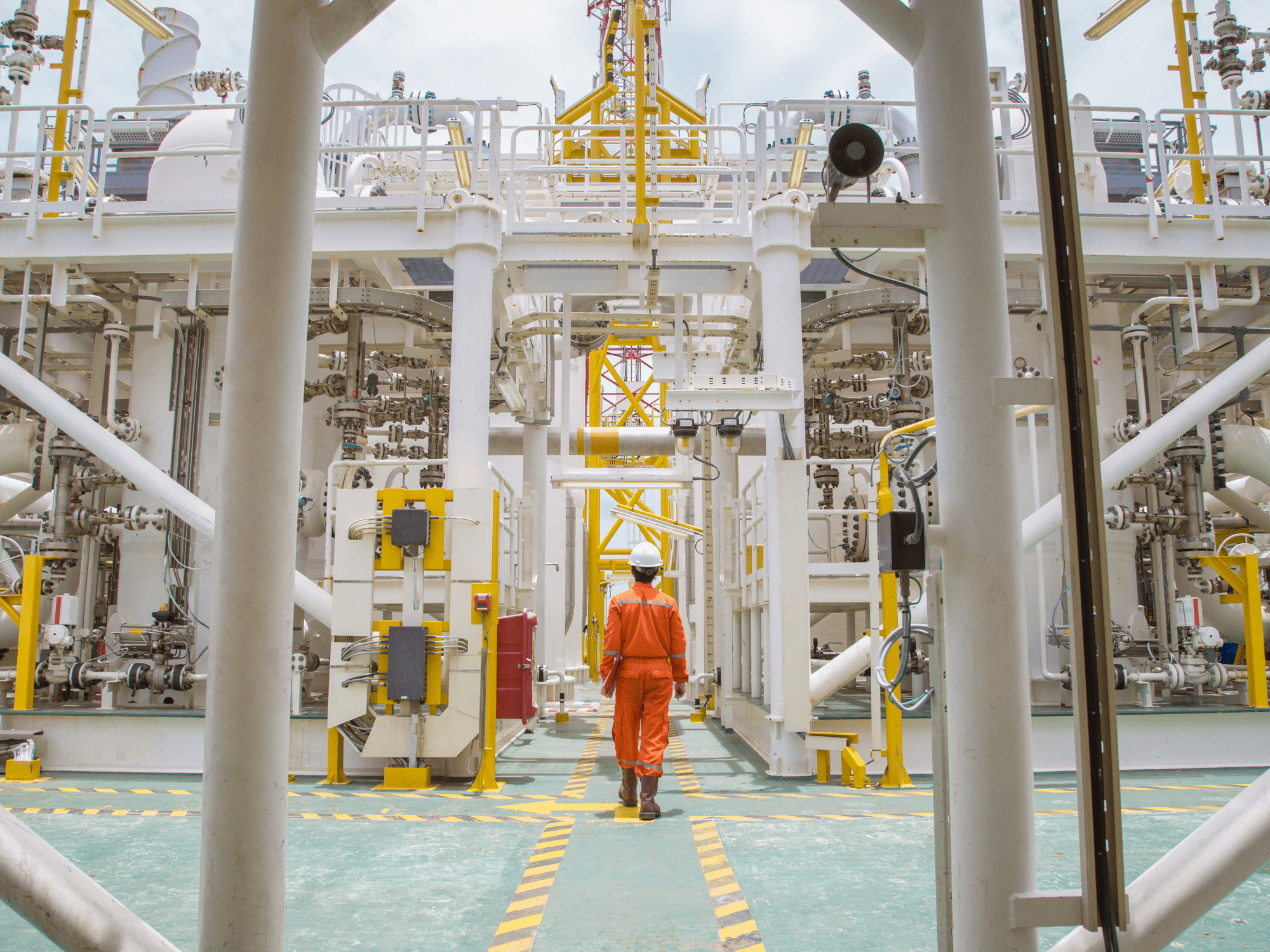 Site Operations Man Dressed In Orange Standing On Oil Rig