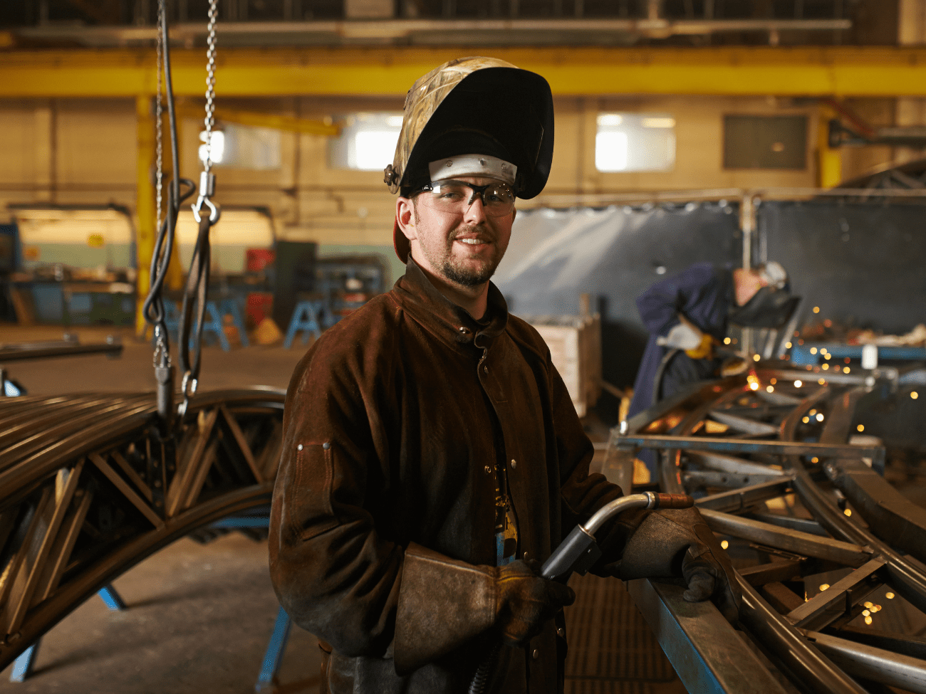 Apprentice Wearing PPE Working On Metal Welding