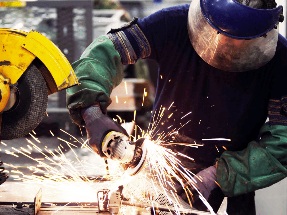 Man In PPE Working With Abrasive Wheels