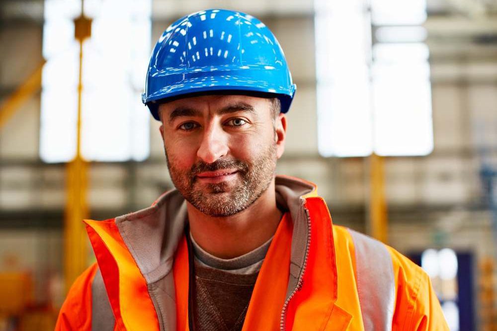 Man In Blue Hard Hat And Orange PPE Aspect Ratio 1200 800