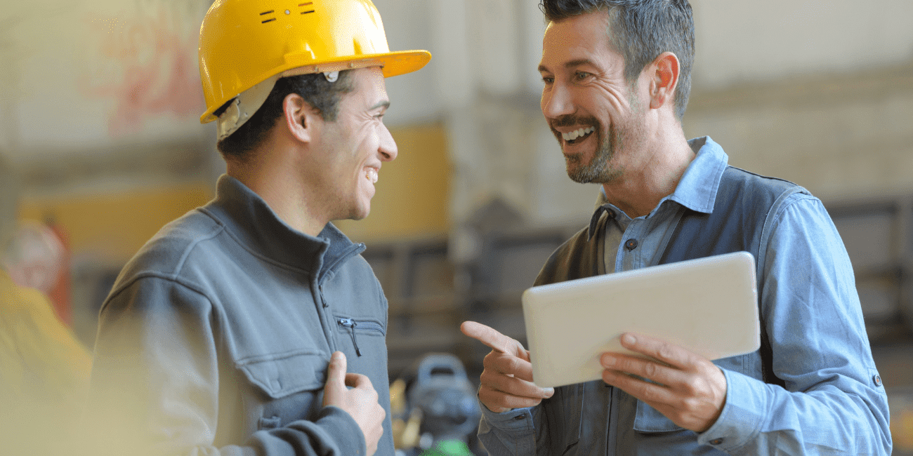 Man In Hard Hat And Man With Tablet Smiling  Aspect Ratio 1160 580
