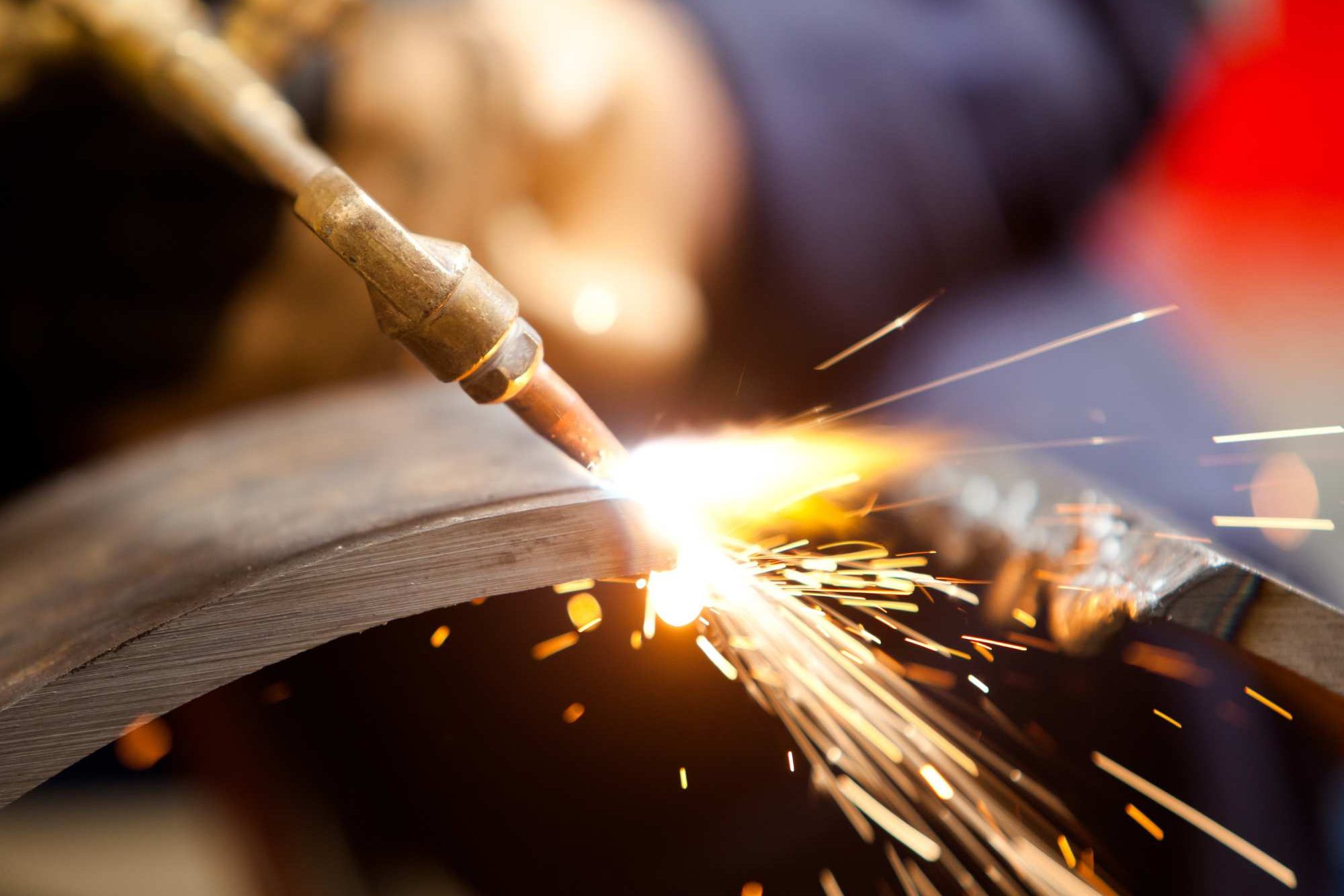 Person Welding Wearing PPE Aspect Ratio 1200 800