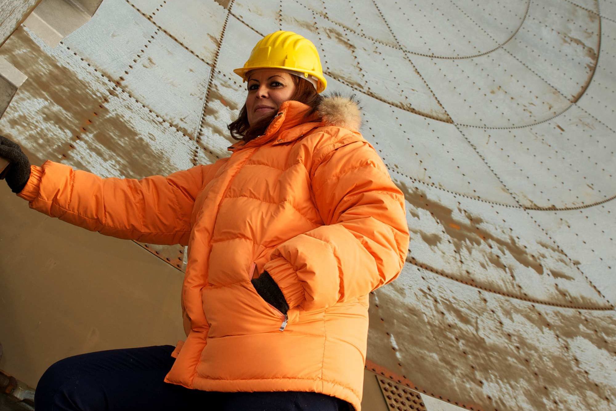 Woman In Orange Coat In Tower Aspect Ratio 1200 800