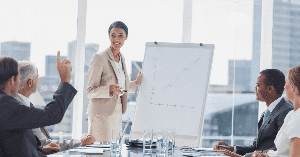 Woman Presenting Graph In Office Meeting Aspect Ratio 760 400