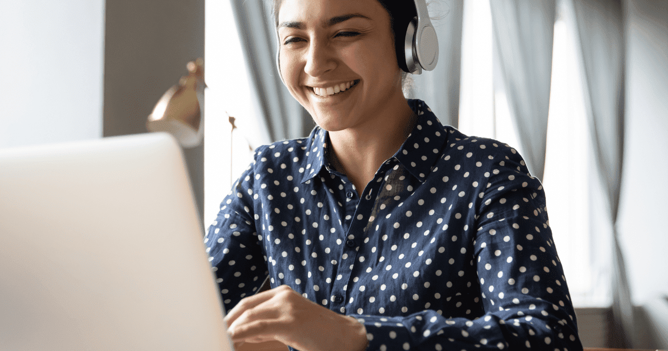 Woman Wearing Headphones Working On A Laptop Aspect Ratio 760 400