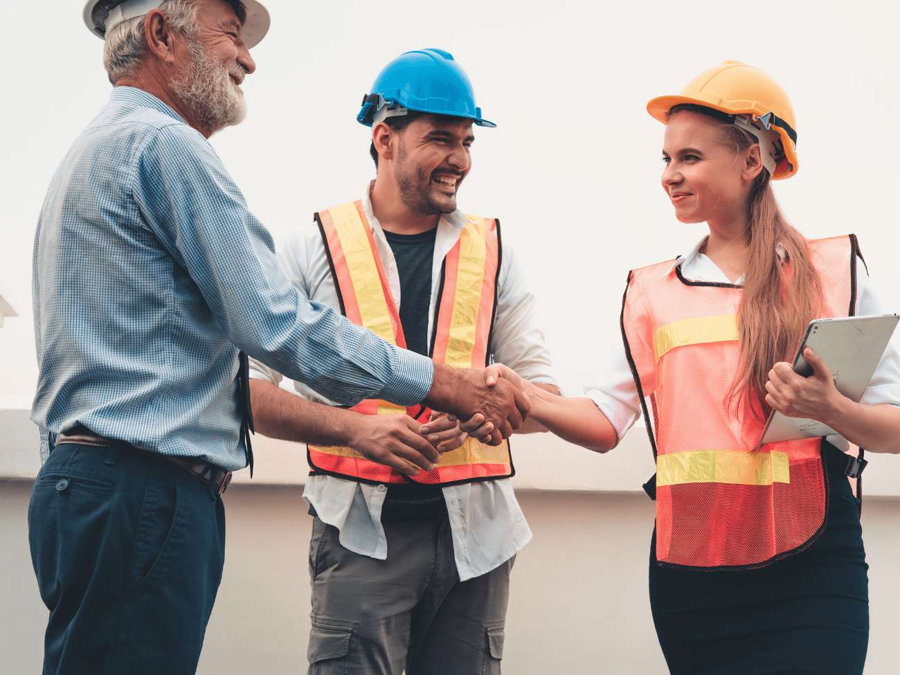 Woman With Tablet Shaking Hands With Man In Hard Hat