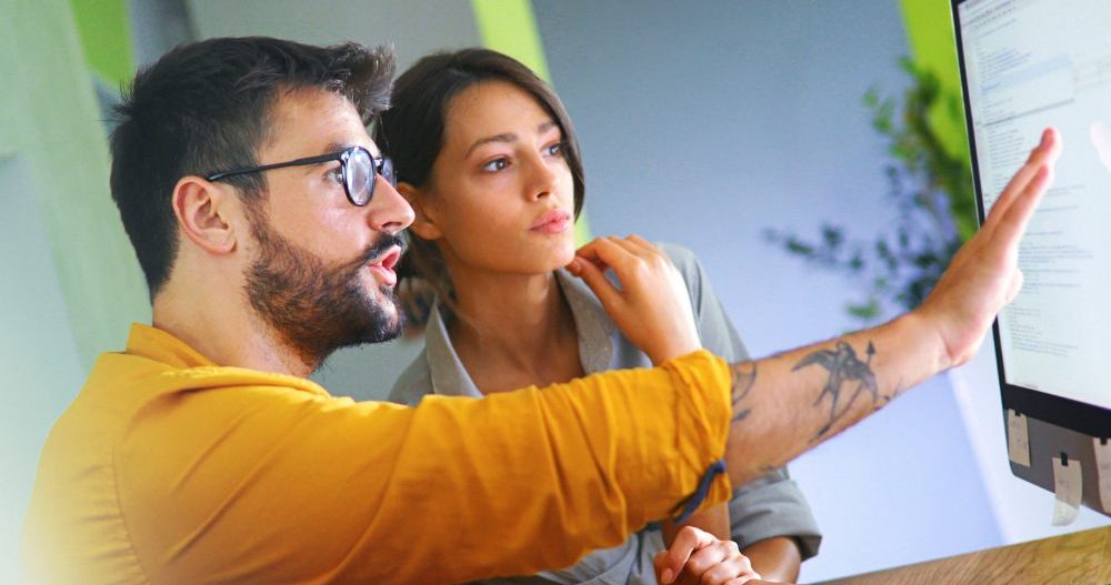 Two People Working On A Computer In An Office Aspect Ratio 760 400